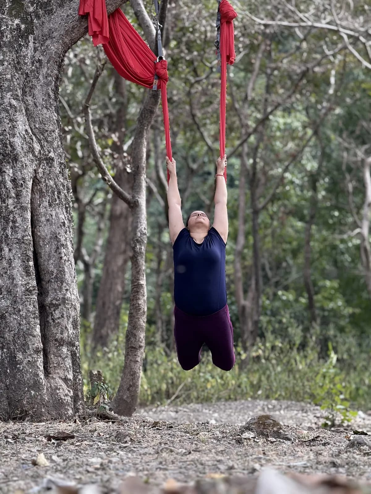 Trainees of different ages and body types practising side by side in hammocks
