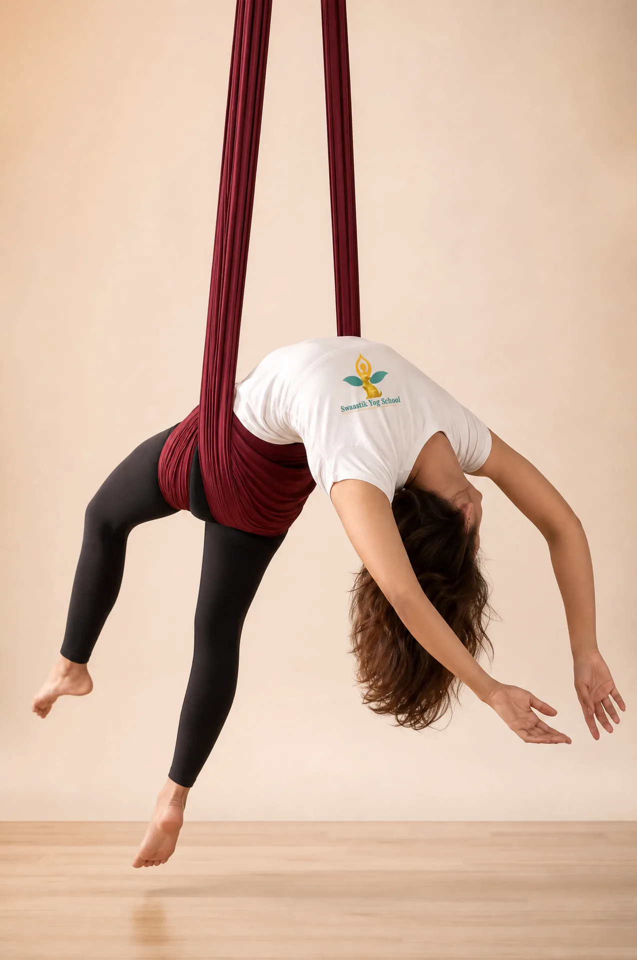 A supported backbend over the hammock, feet grounded on the mat