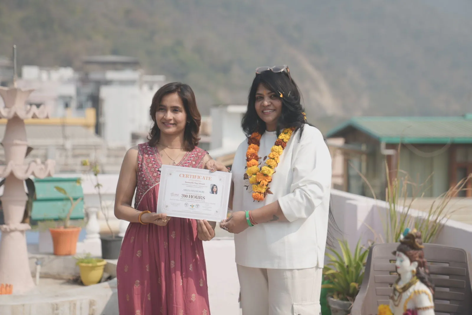 A graduate receiving her certificate at the end of the training